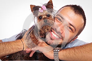 Man is holding his pet yorkshire terrier puppy dog