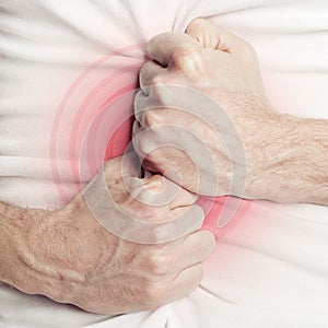 Man holding his stomach in pain or indigestion photo