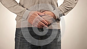 Man holding his stomach in pain. Men problems on white background. Medical concept