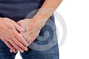 Man holding his urethra in pain. Men problems on white background. Medical concept