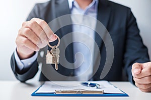 Man holding home key during signing home contract documents. Contract agreement, real estate,  buy and sale and insurance concepts