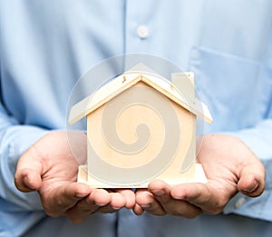 Man holding house representing home ownership