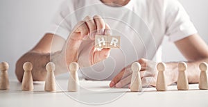Man holding HR word on wooden cubes. Human Resources photo