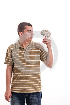 Man holding a human brain model and looked at him
