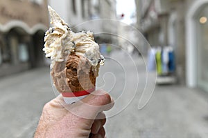 A man is holding an ice cream cone