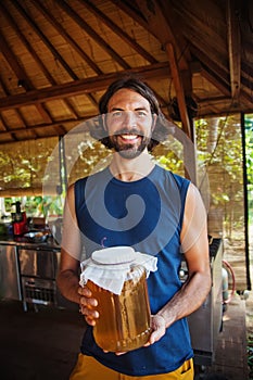 Man holding a jar of honey