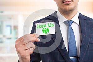 Man holding join us card