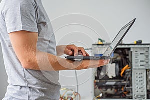 Man holding laptop to diagnose problem