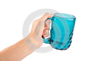Man holding a large fancy blue transparent glass mug in hand, doing a cheers gesture, isolated on white, cut out, first person pov