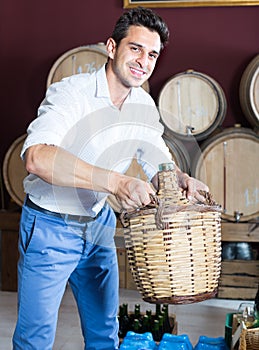 Man holding large wine bottle