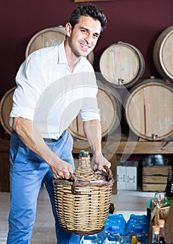 man holding large wine bottle