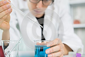 Man holding and lean glass dropping pipet