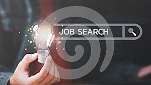 Man holding light bulb showing online job search concept ,career search ideas, recruitment, unemployed person ,new graduates ,job