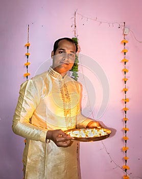 Man holding lighted candles many kept in plat for diwali cultural celebration lightnings