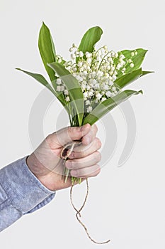 Man holding lily of valley flower bouquet