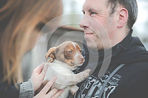 Man holding little puppy dog