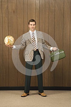 Man holding luggage and globe