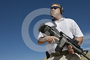 Man Holding Machine Gun At Firing Range