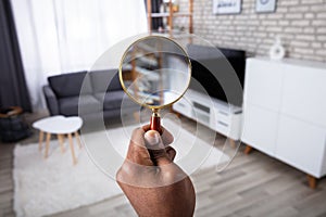 Man Holding Magnifying Glass