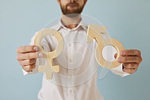 Man holding male and female gender symbols showing concept of sexuality and relationship