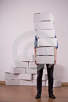 Man holding many cardboard boxes