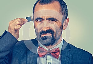 Man holding Micro SD card near his head