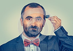 Man holding Micro SD card near his head