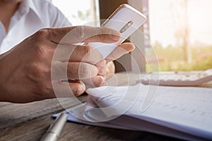 Man holding mobile in hand, reading text on cell phone