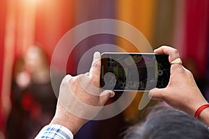 Man holding mobile phones and shoot video