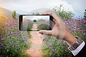 Man holding mobile smart phone taking