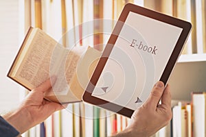 Man holding a modern ebook reader and book