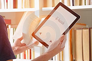 Man holding a modern ebook reader and book