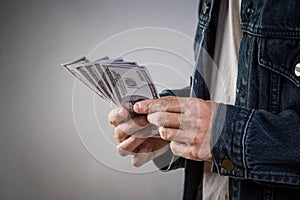 Man holding money bills for playing casino gamble.