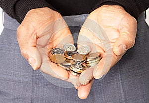 Man holding money coins in his hands