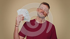 Man holding money dollar cash like a fan, success business career, lottery winner, income, wealth