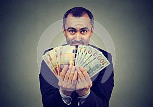 Man holding money euro and dollars banknotes