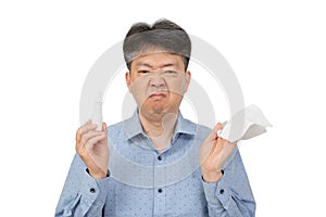 A man holding a nasal spray in his hand on white background