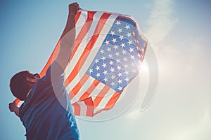 Man holding national USA flag. Celebrating Independence Day of America. July 4th