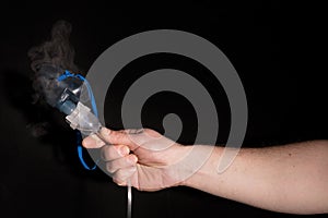 Man holding nebulizer mask with vapour