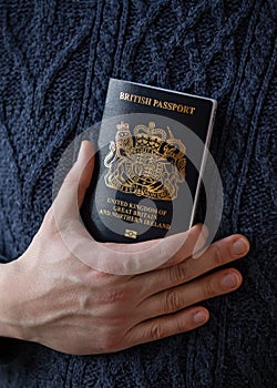 man holding new post Brexit blue British passport Devon, United Kingdom, January, 2021