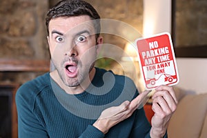 Man holding no parking sign