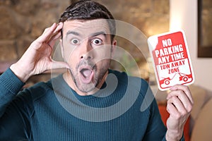 Man holding no parking sign