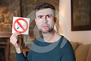 Man holding no smoking sign