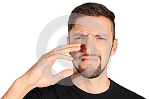 Man holding nose against bad smell.