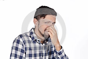 Man holding nose against bad smell.