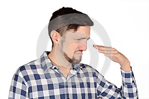 Man holding nose against bad smell.