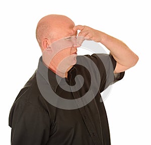 Man holding nose due bad smell