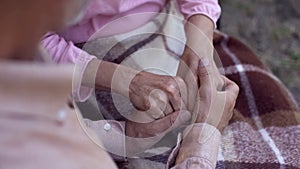 Man holding old female hands, family love and care, old couple in nursing home