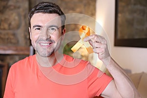 Man holding an orange ribbon