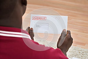 Man Holding Overdue Notice